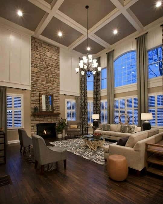 Country style living room, high ceilings, couch, fireplace, chandelier