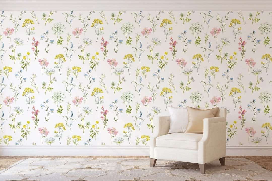 Living room with floral wallpaper and white accent chair 