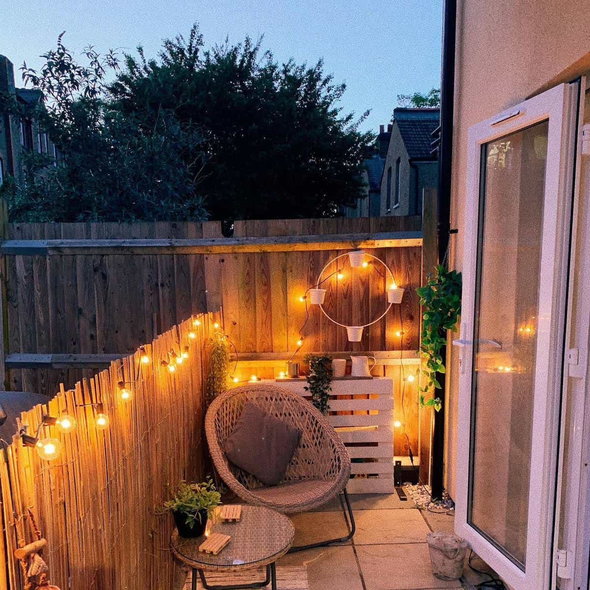 Small backyard with bamboo fence and fairy lights