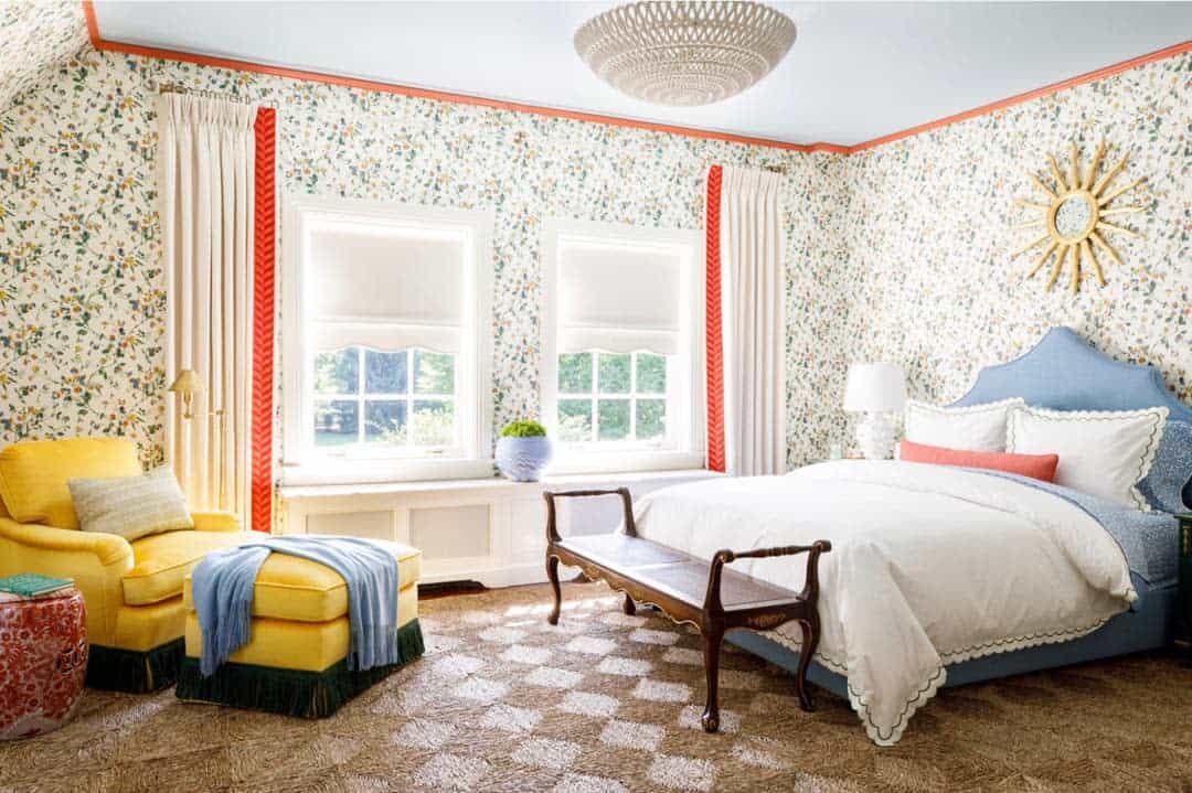 Floral wallpaper in master bedroom with yellow accent chair 