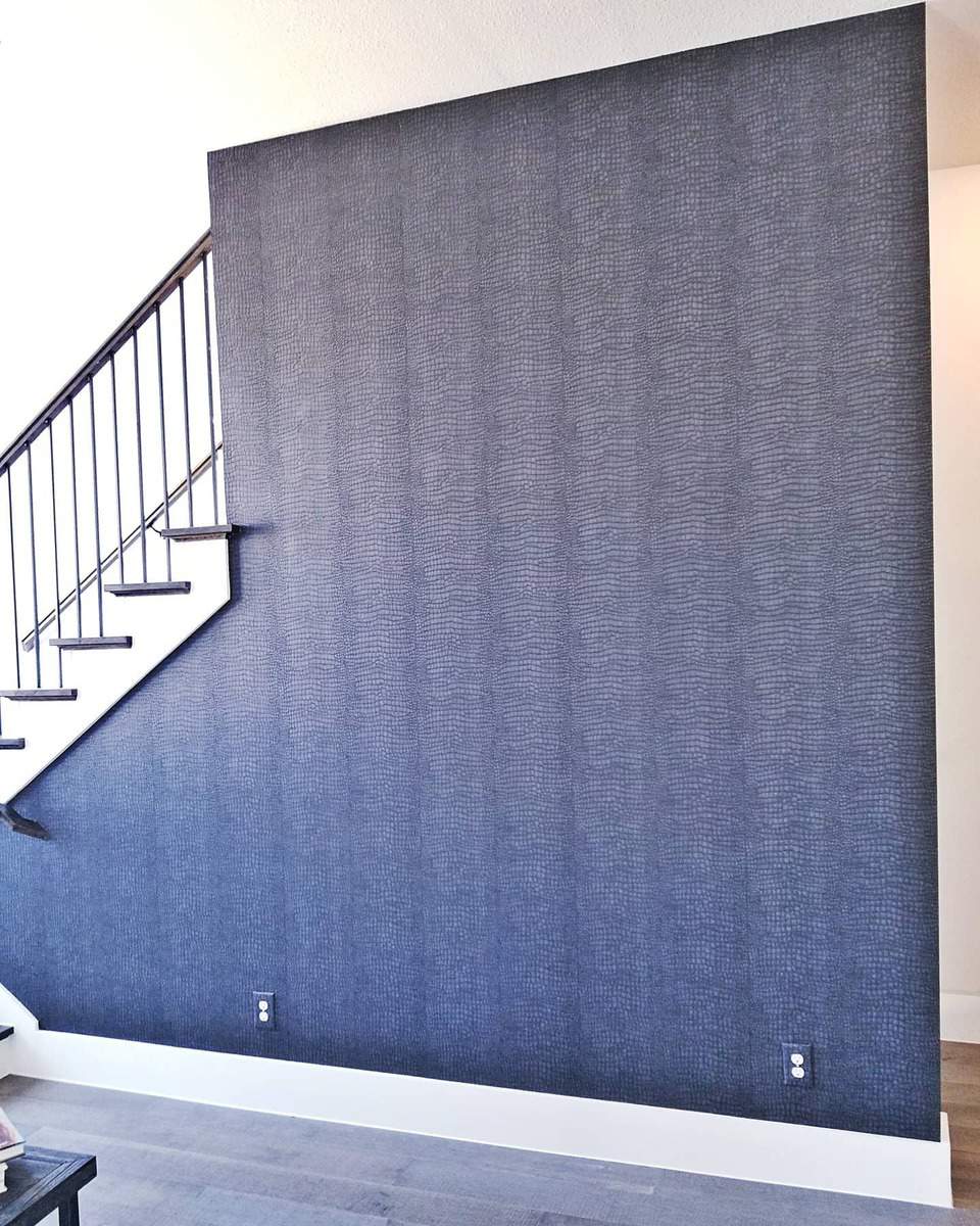 Accent wall with blue wallpaper on the stairs 