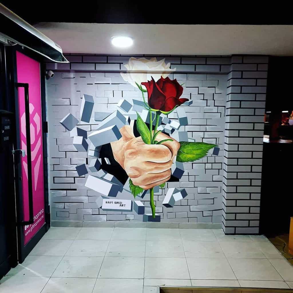 3D fist with red rose breaking through bricks 