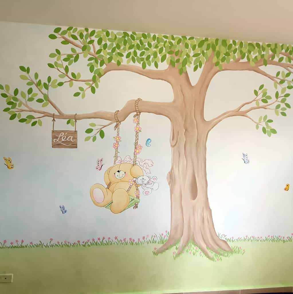 Hand-painted mural with a teddy bear on a swing 