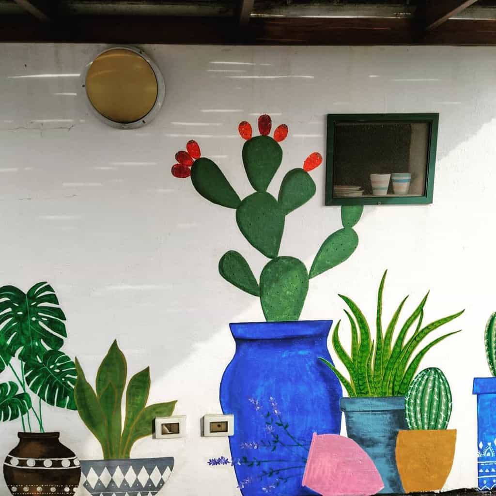 Hand painted plants in pots as a mural in the backyard 