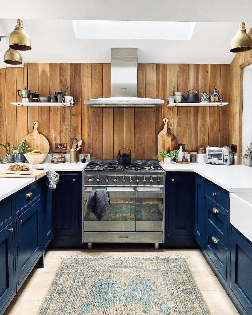 Modern rustic kitchen with wood paneling and blue cabinets 