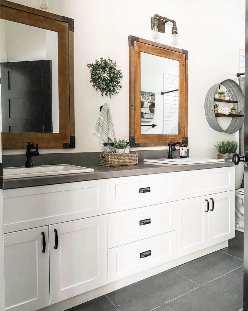 Rustic bathroom with white cabinet and two mirrors 