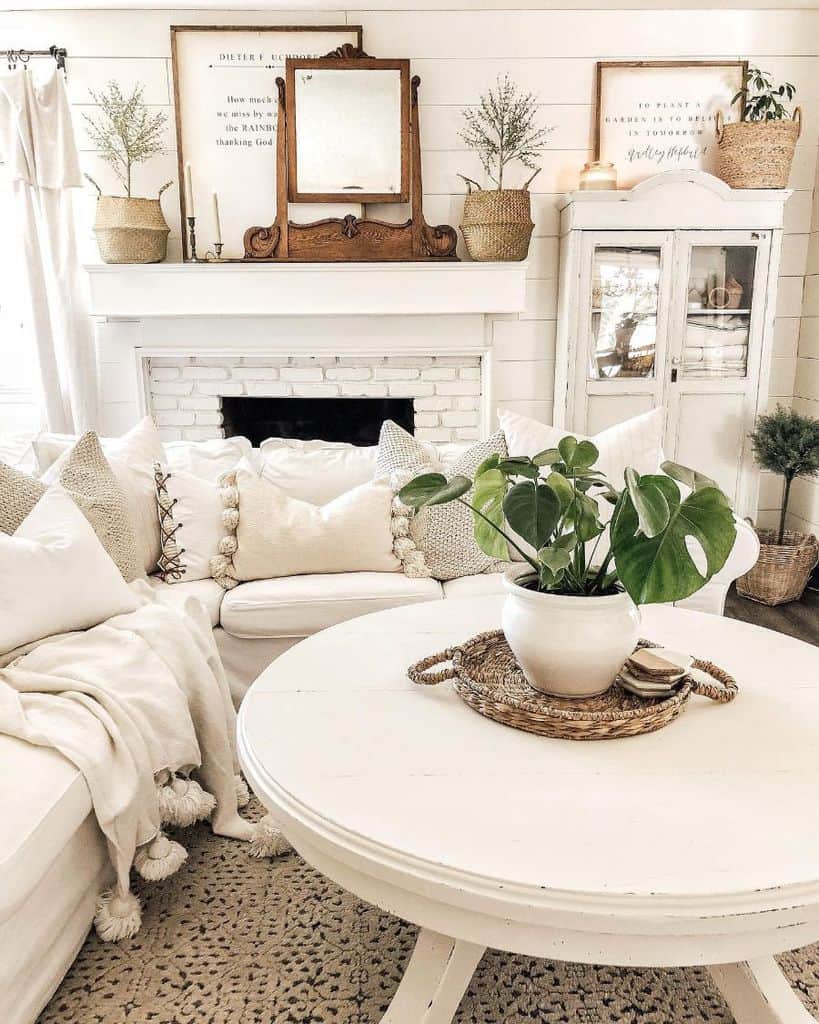 White, rustic living room with brick fireplace 
