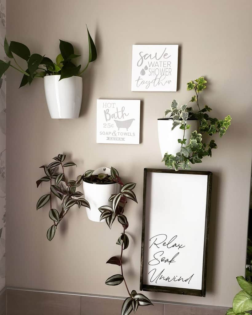 White hanging potted plants and wall art in the bathroom 