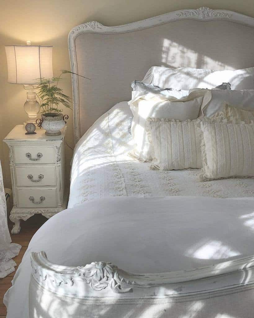 French country bedroom with white bed and nightstand 