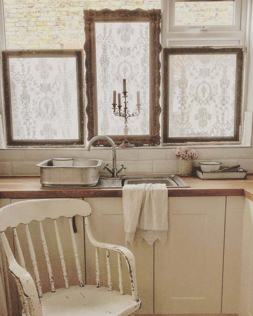 Country house kitchen, framed sample windows, candlesticks, white chair 