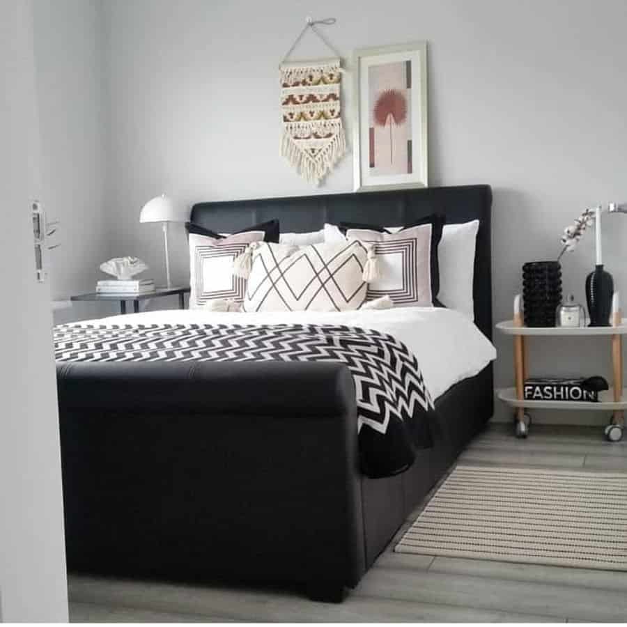 Black frame bed in a small gray modern bedroom 