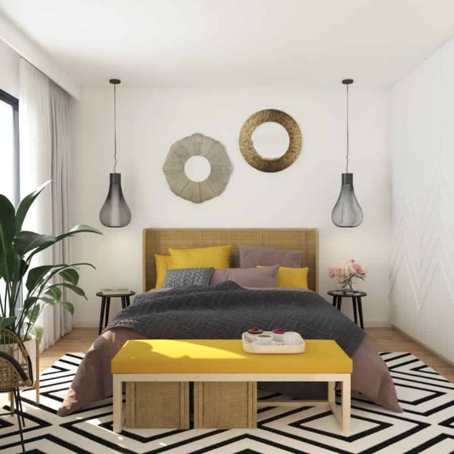 small modern bedroom with yellow ottoman 