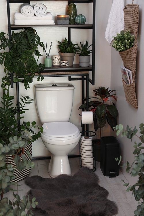 Plants around the toilet seat in the bathroom 23