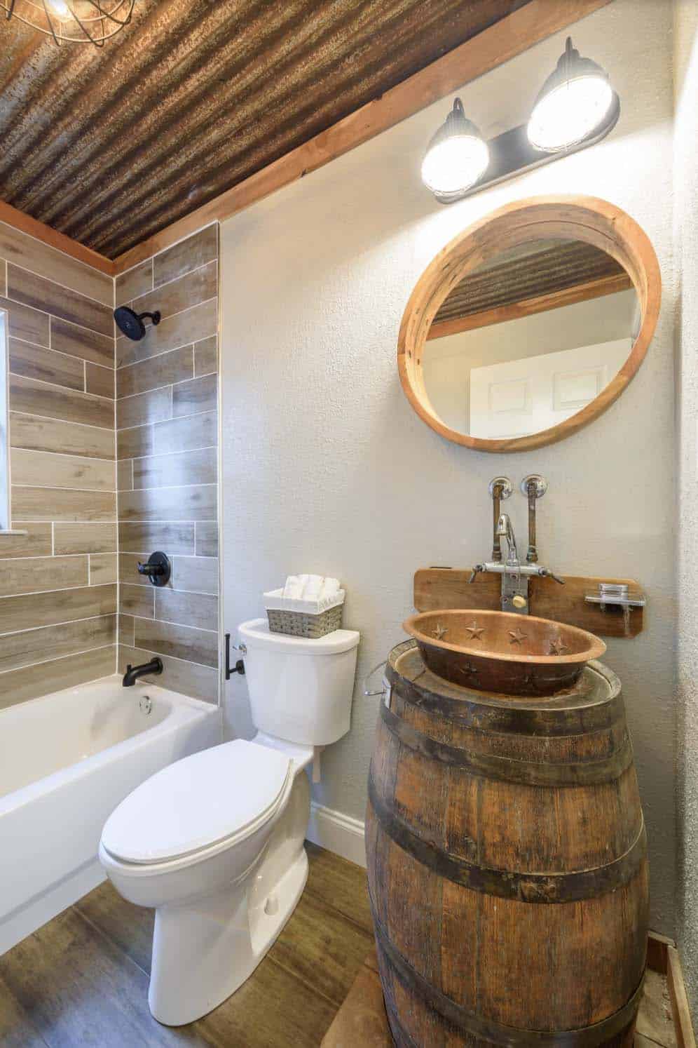 Custom whiskey barrel bathroom vanity with a hammered copper sink