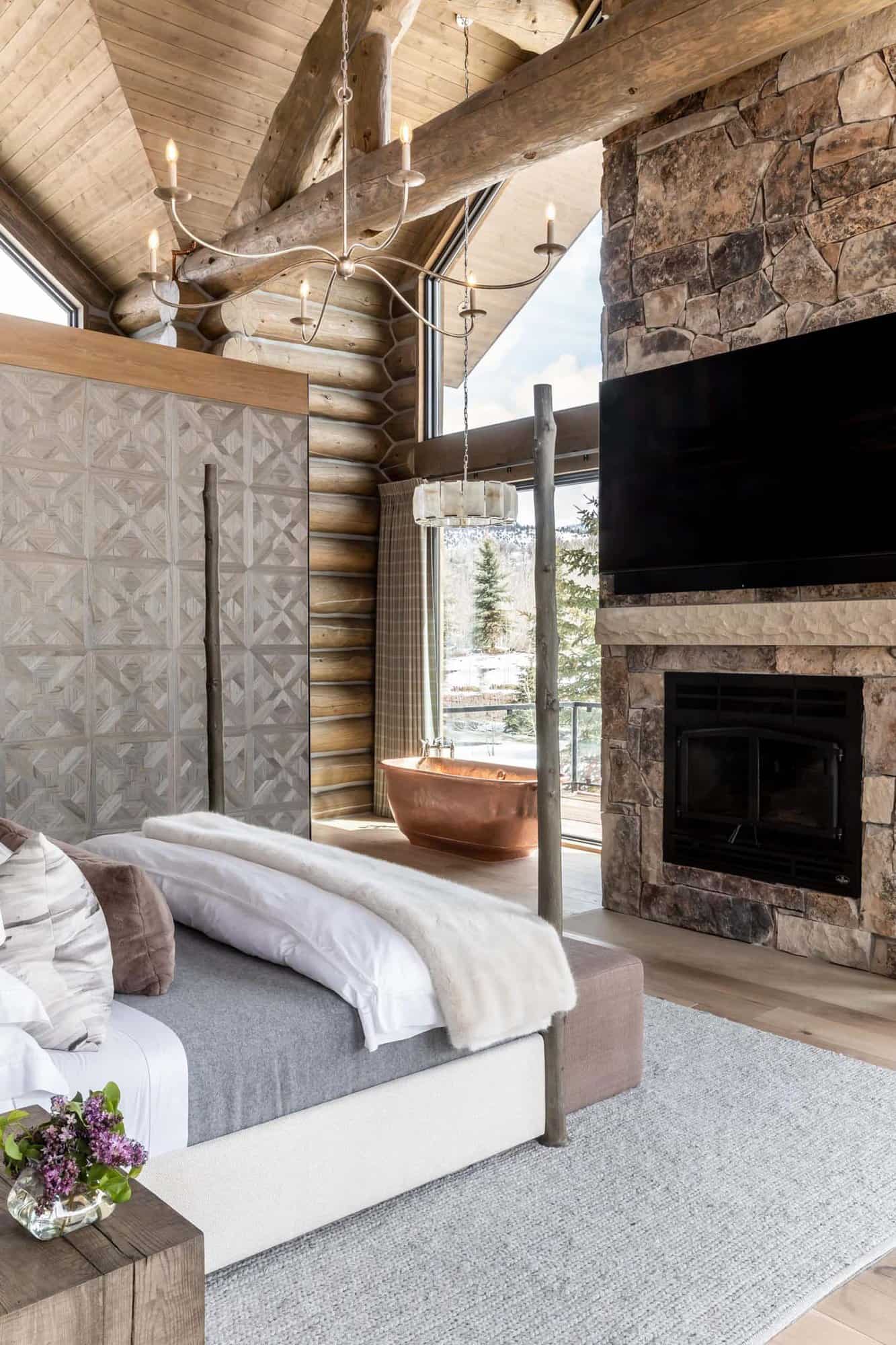 Log cabin bedroom with four-poster bed, fireplace and copper bathtub