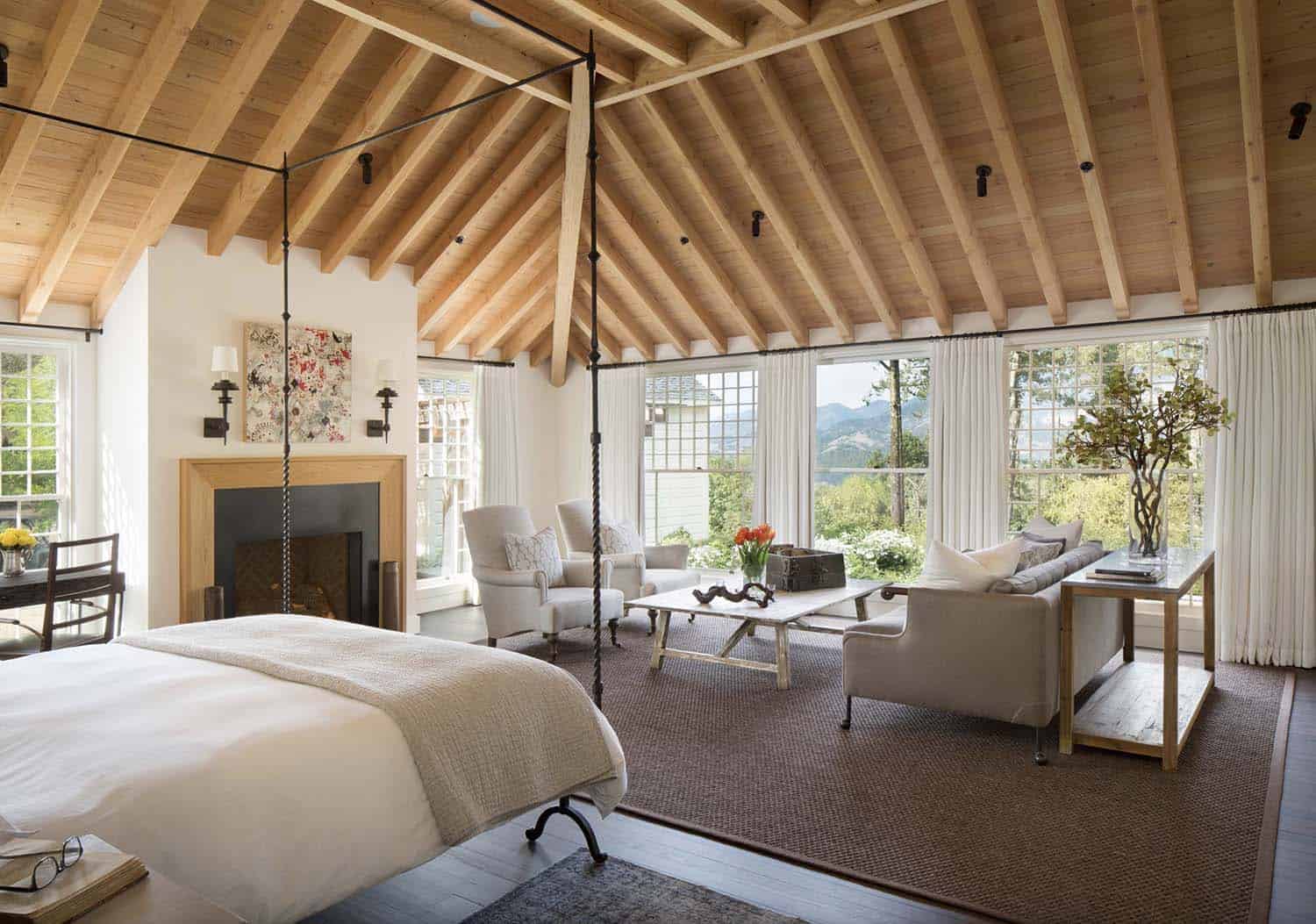 Romantic country-house style bedroom with wooden ceiling and fireplace