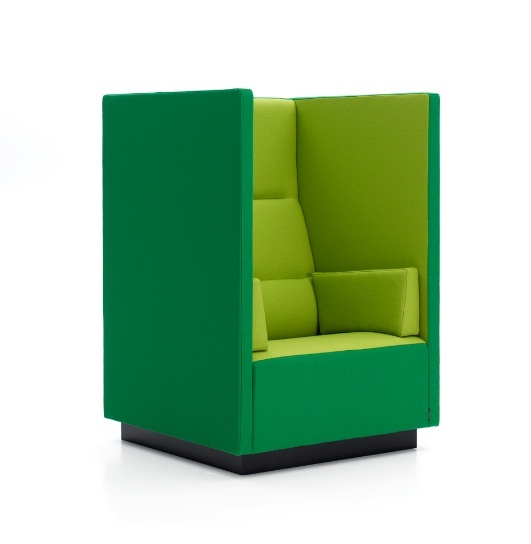 A tall chair in emerald green and lime green with high sides allows for a more intimate seating experience, perfect for introverts