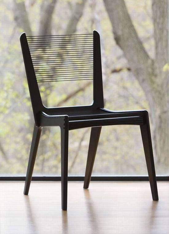 A black thread-back chair that looks airy and light is a cool idea for a modern space