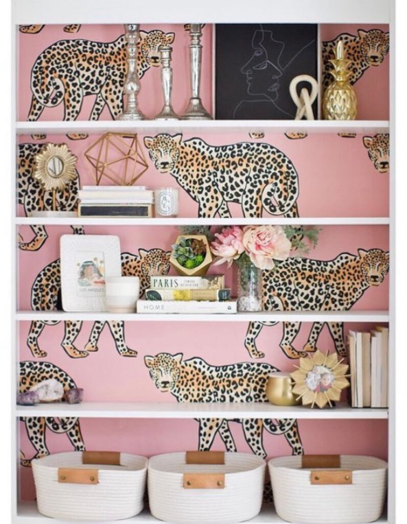 Glamorous pink leopard print wallpaper on white bookshelf