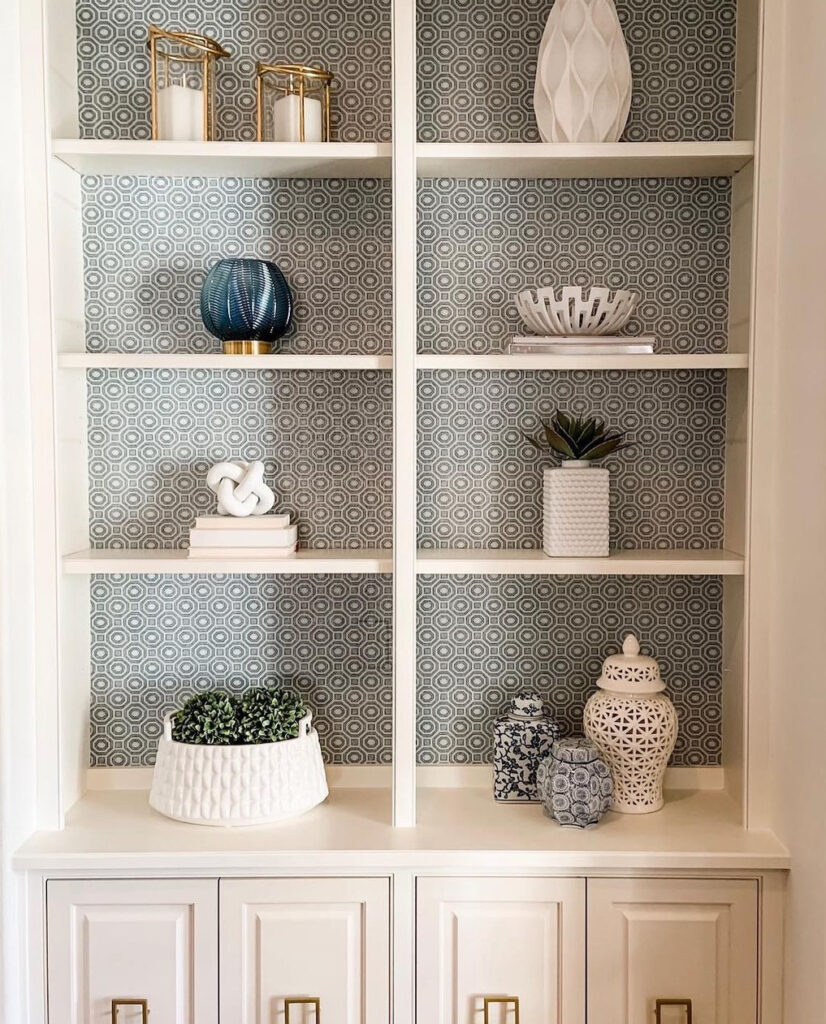 Blue and white geometric wallpaper on shelves with minimalist decor