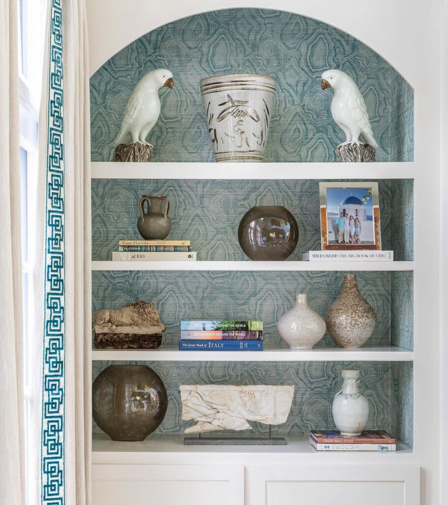 European coastal style built-in bookcase with light blue wallpaper