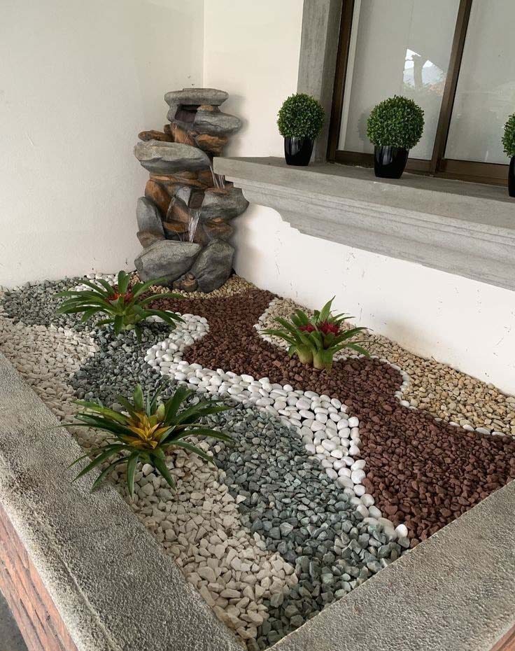 Modern front garden with small pebbles