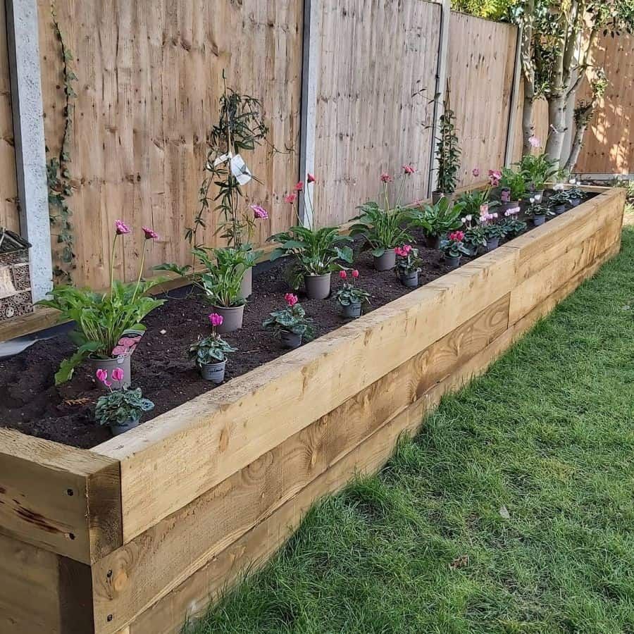 Beautiful Flower Beds Along the Fence: A Creative and Functional Garden Design Idea