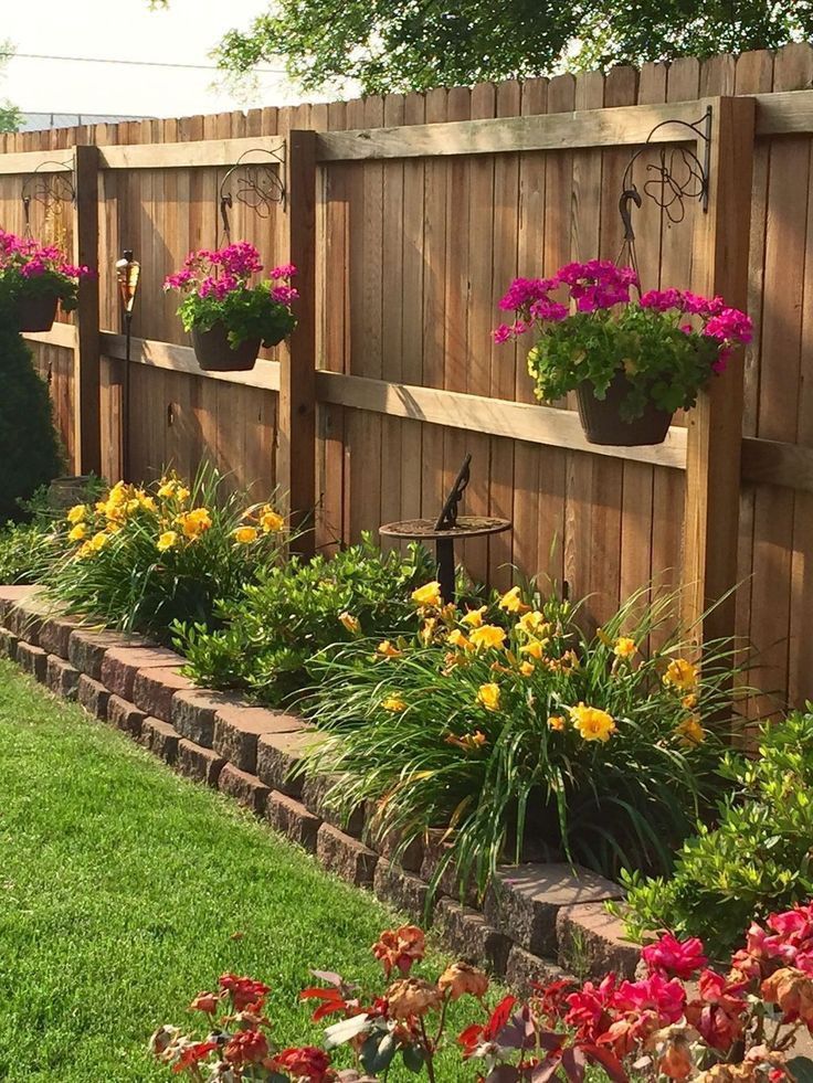 Enhancing Your Garden with Elevated Flower Beds Aligned Along a Fence Line