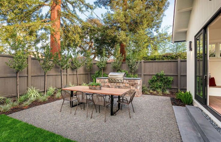 Cozy Backyard Gravel Patio with Outdoor Kitch