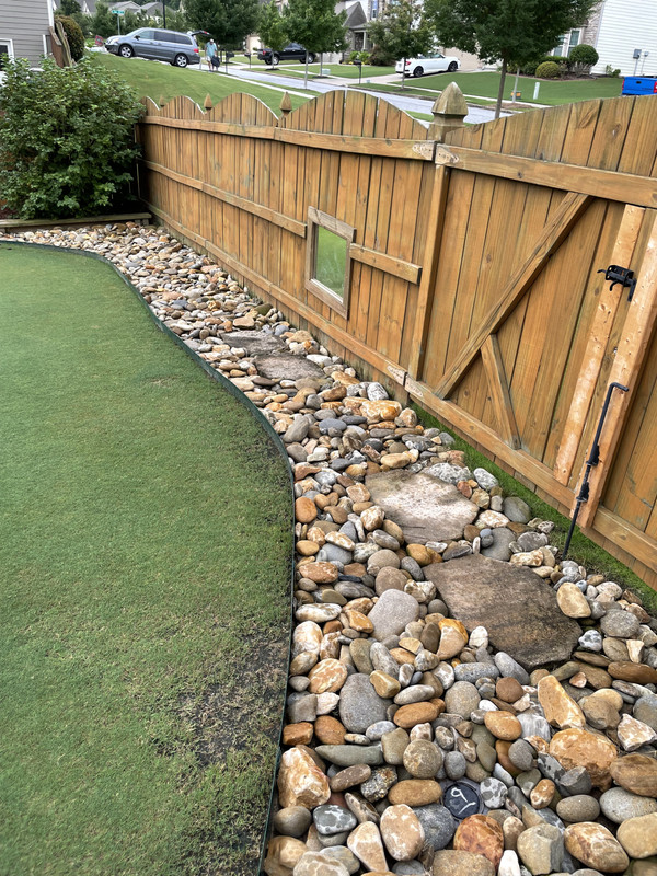 Rock border along fence line | Lawn Care For