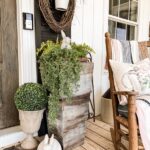 Farmhouse Porch Ideas for Spring with faux flowers and greene